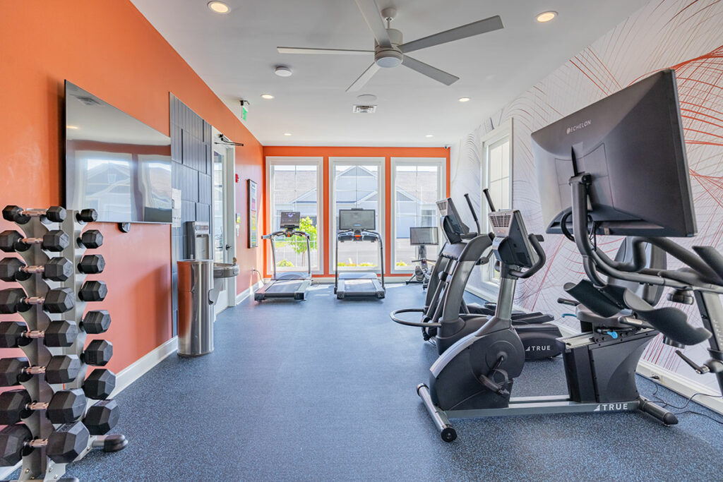 Fully equipped fitness center with bikes, treadmills, ellipticals, and free weights