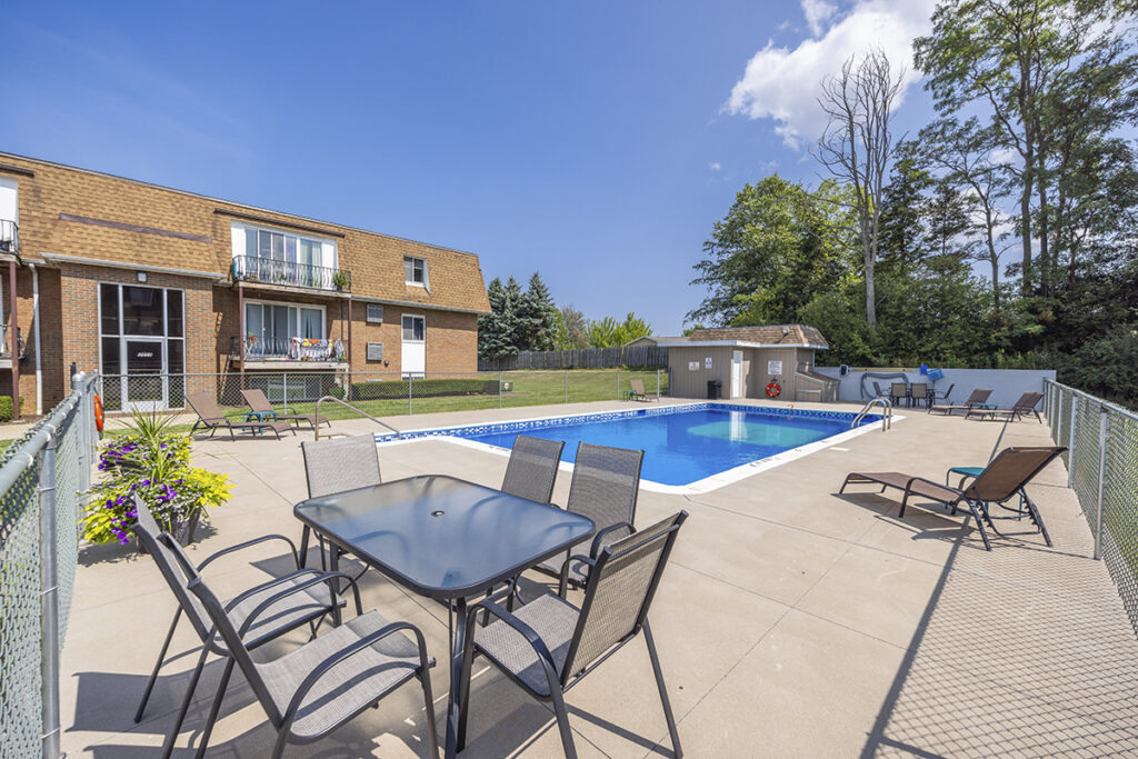 Updated swimming pool and sundeck at Royal Villa Apartments in Erie, PA, featuring brand new furniture and a freshly renovated pool area.