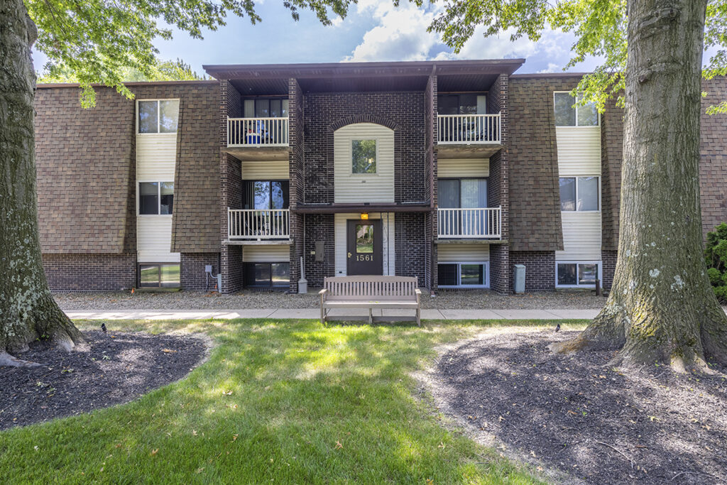 Exterior view of Winchester Apartments & Townhomes, featuring well-maintained buildings with private patios overlooking the landscaped courtyard.