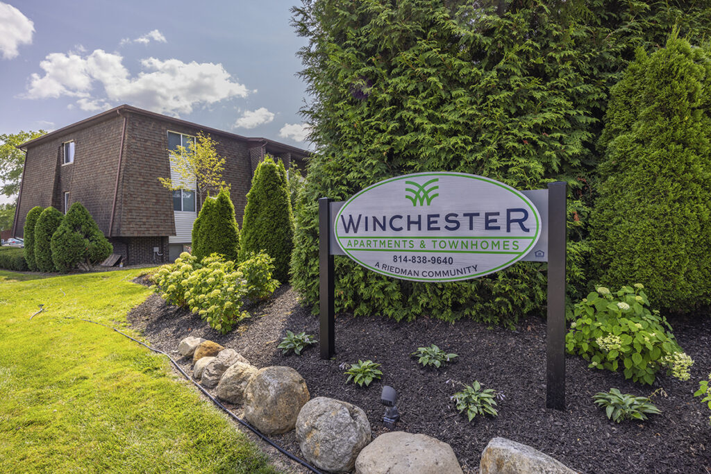 Community sign for Winchester Apartments & Townhomes, showcasing the entrance and branding of the residential community.