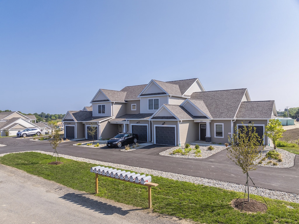 A beautiful apartment building at The Hammocks at Fairview featuring six homes, each with a private entrance and five one-car garages. The building is set in a serene environment, away from the high school.