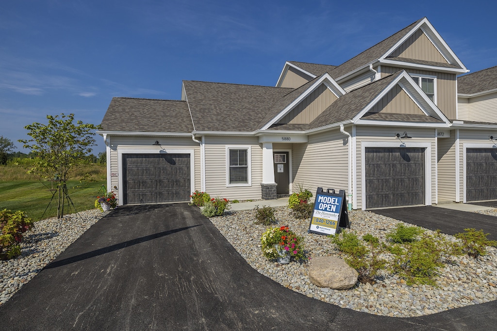 The entrance to the model home at The Hammocks at Fairview, showcasing a welcoming front door, a private walkway, and a neatly landscaped entry area. The design emphasizes both privacy and curb appeal.