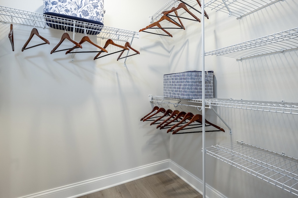 Large walk-in closet with built-in shelves, providing abundant storage space for clothes and accessories.