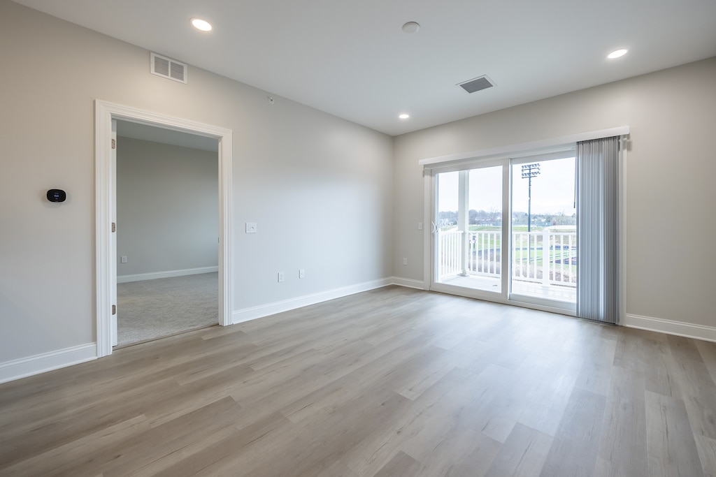 Experience luxury vinyl plank flooring in the stylish living room of Fairview's Upper Unit. Step out onto your private balcony to immerse yourself in breathtaking views.
