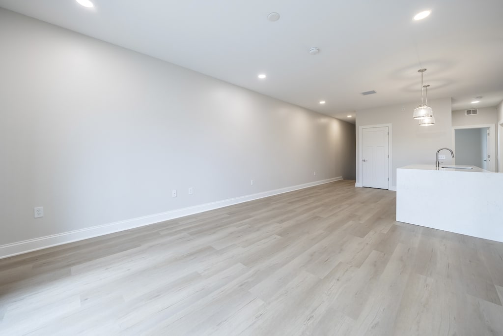 Spacious upper unit with open floor plan, featuring ample natural light and modern design elements.