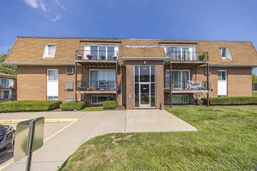 Royal Villa Apartments in Erie, PA, displaying a brick building exterior with private balconies and controlled building entrances.