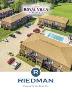 Aerial view of the Royal Villa Apartments complex with several cars parked and a swimming pool visible. The logo at the bottom reads "Riedman: Changing The Way People Live.