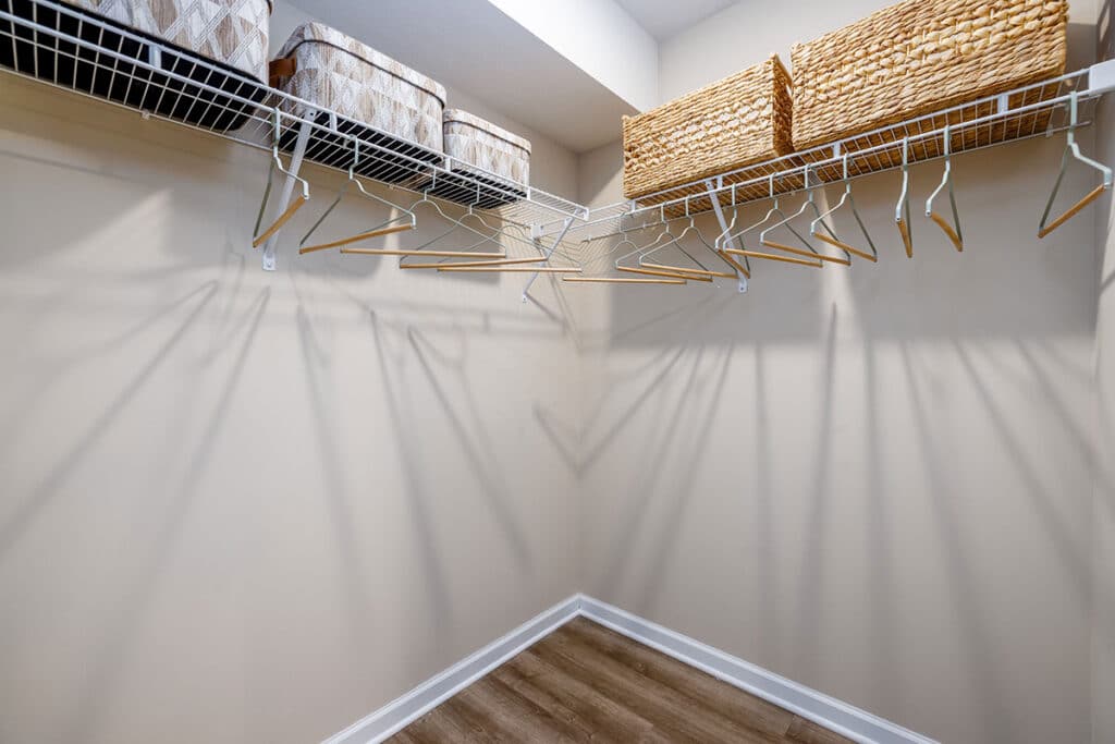 Large walk-in closet with wraparound shelving, hanging space, and built-in storage at The Hammocks at Millcreek
