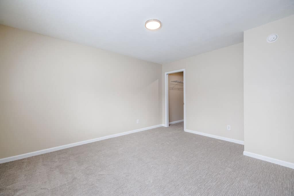 Spacious bedroom at Royal Villa Apartments in Erie, PA with neutral carpet, closet space, and fresh interior finishes.